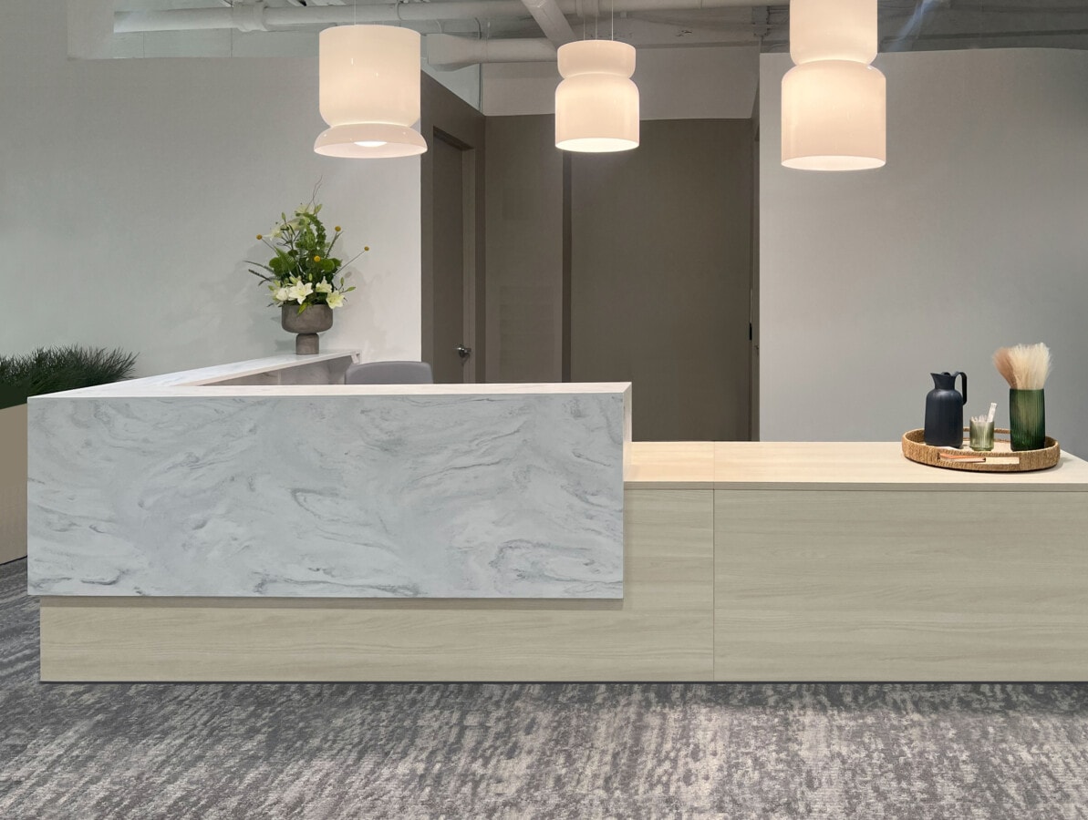 Modern reception desk with marble front panel and pendant lighting